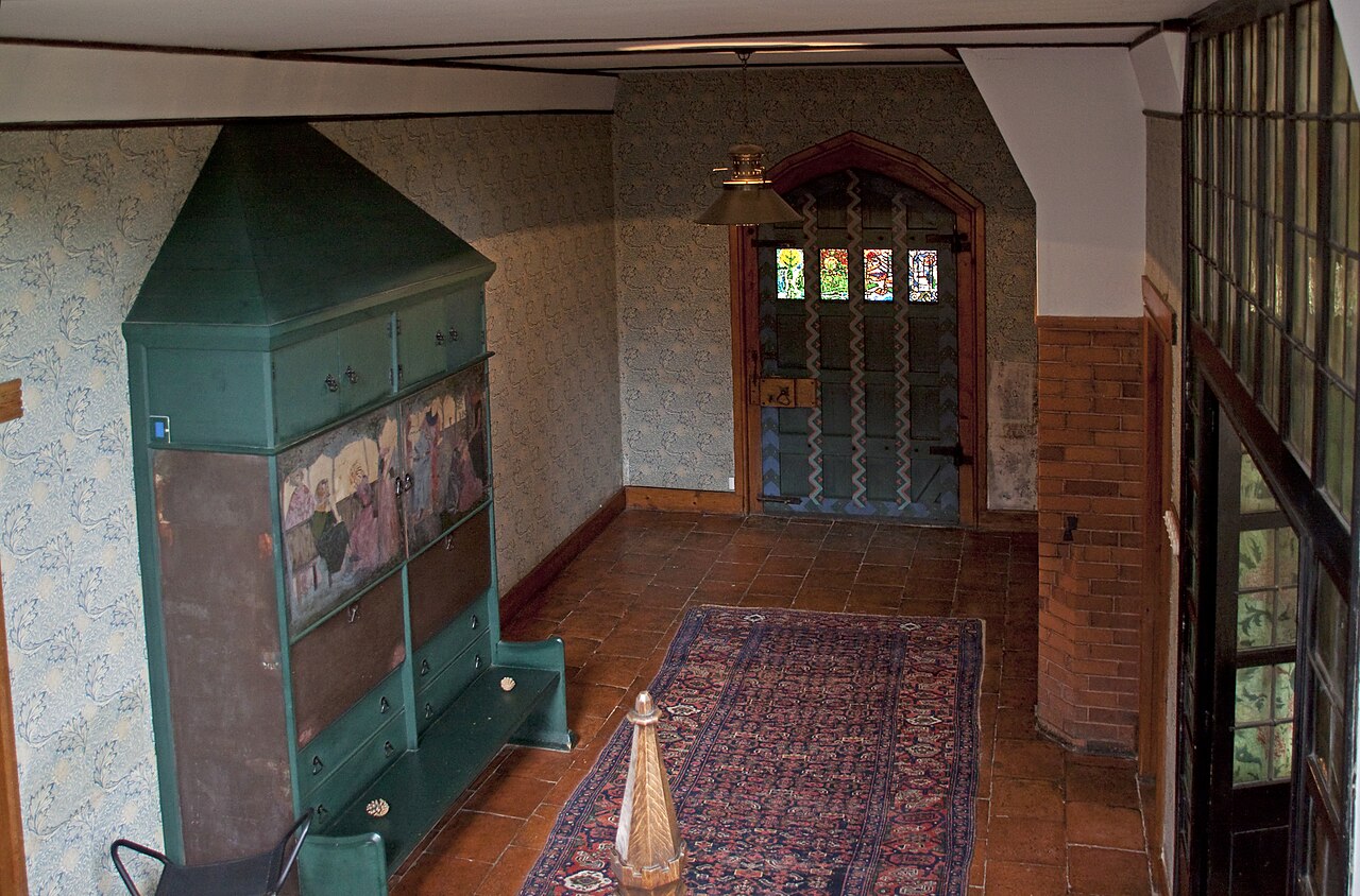 The hall at Red House, William Morris's home in Bexleyheath, with its painted settle
